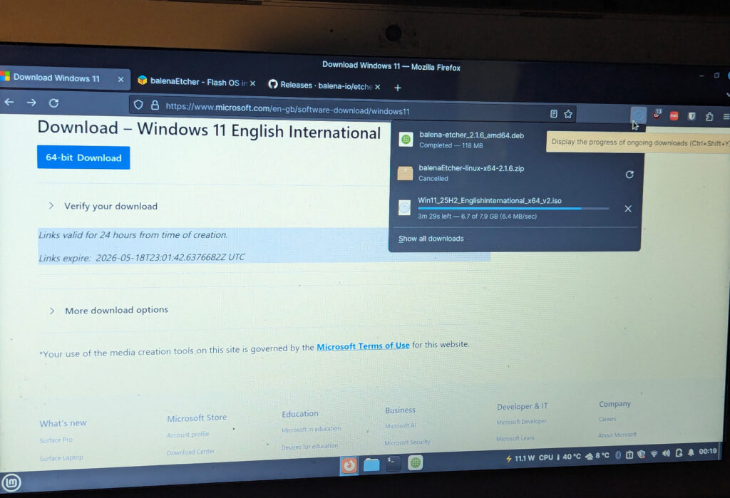 A user is downloading Windows 11 25H2 from Microsoft's website and has downloaded balenaEtcher in a Debian format