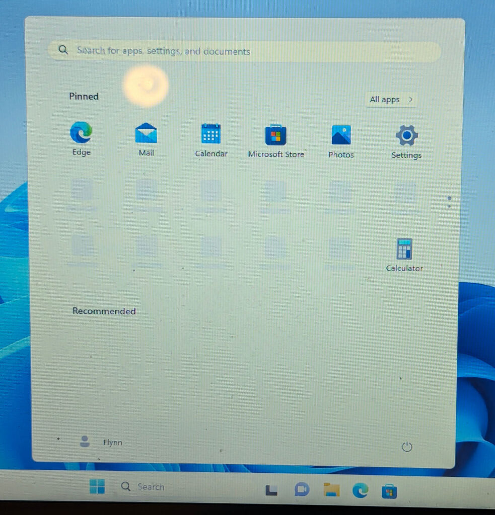 Windows 11 start menu, you see icons for Edge, Mail, Calendar, Microsoft Store, Photos, Settings and Calculator. Some icons haven't loaded in.