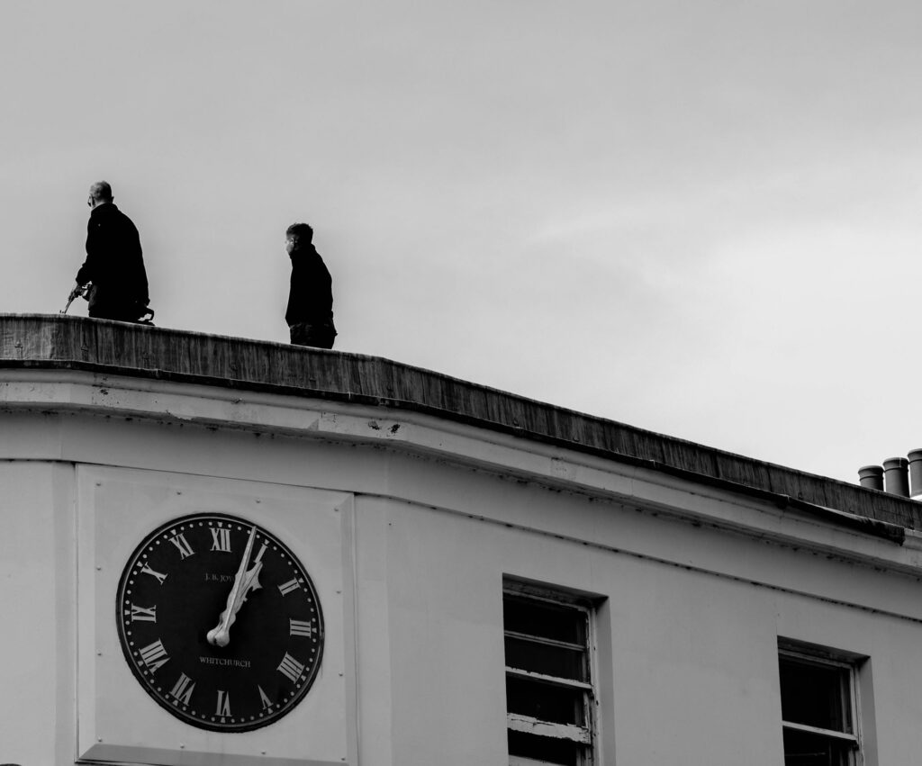 Two men on the roof of a building