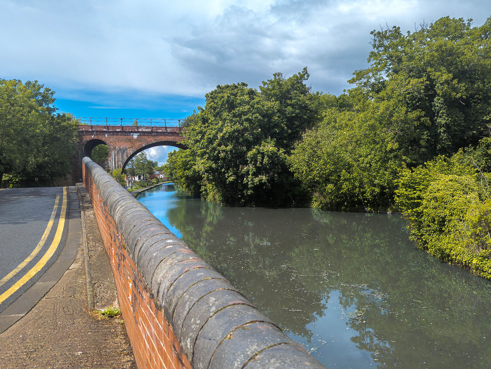Picture of a train passing over a river. The water is very clean.