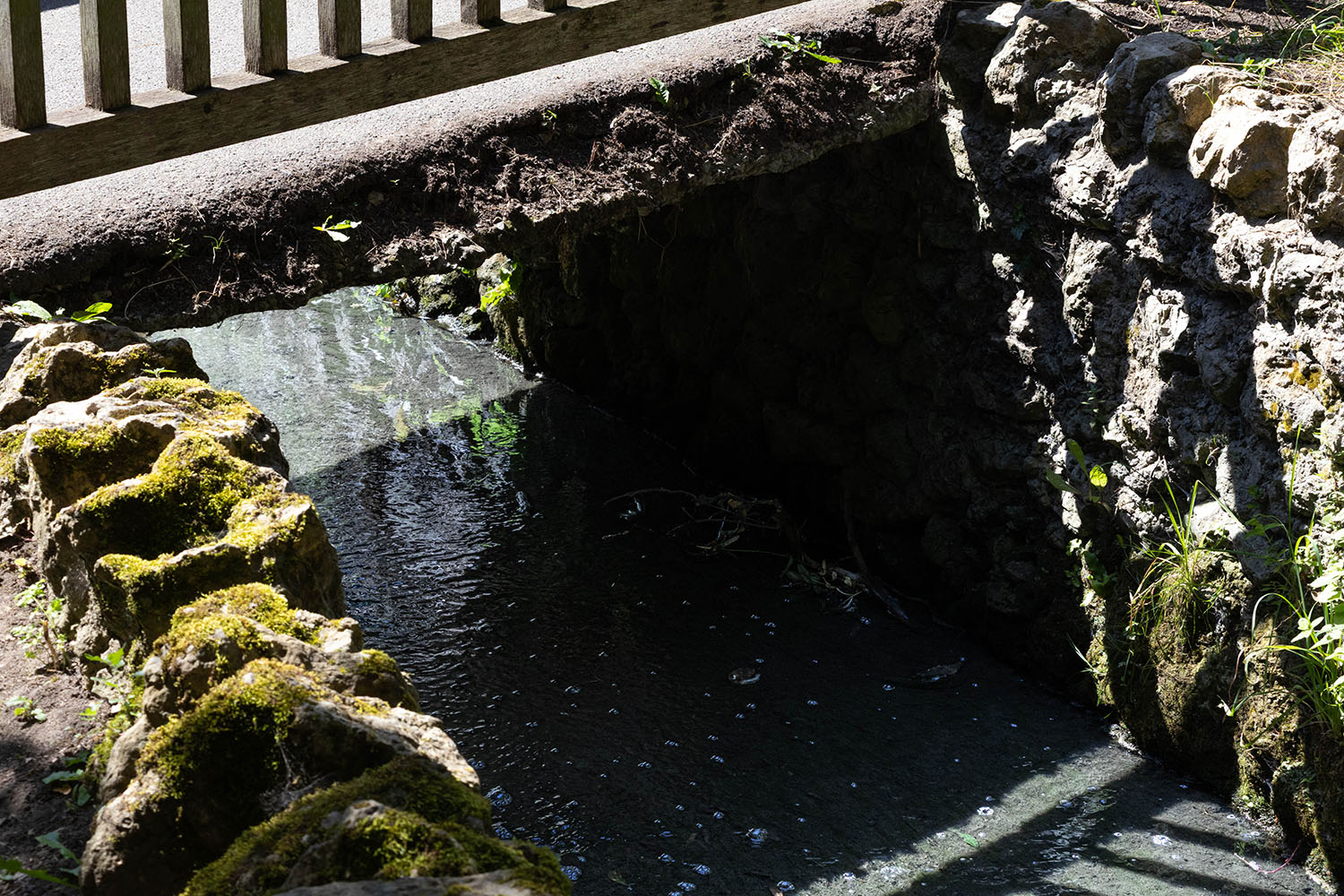 Picture of water flowing under a bridge