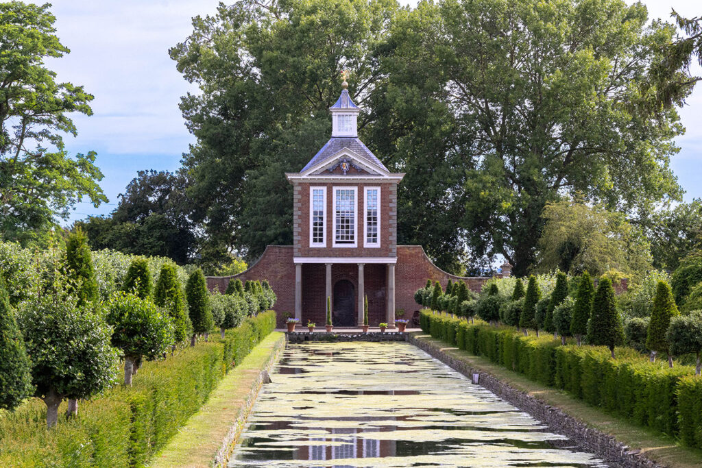 A picture of a building overlooking a water feature