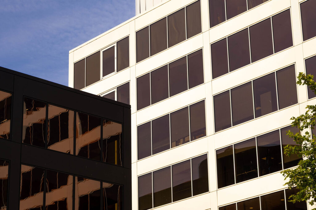 Warm picture of a white building towering above a black one