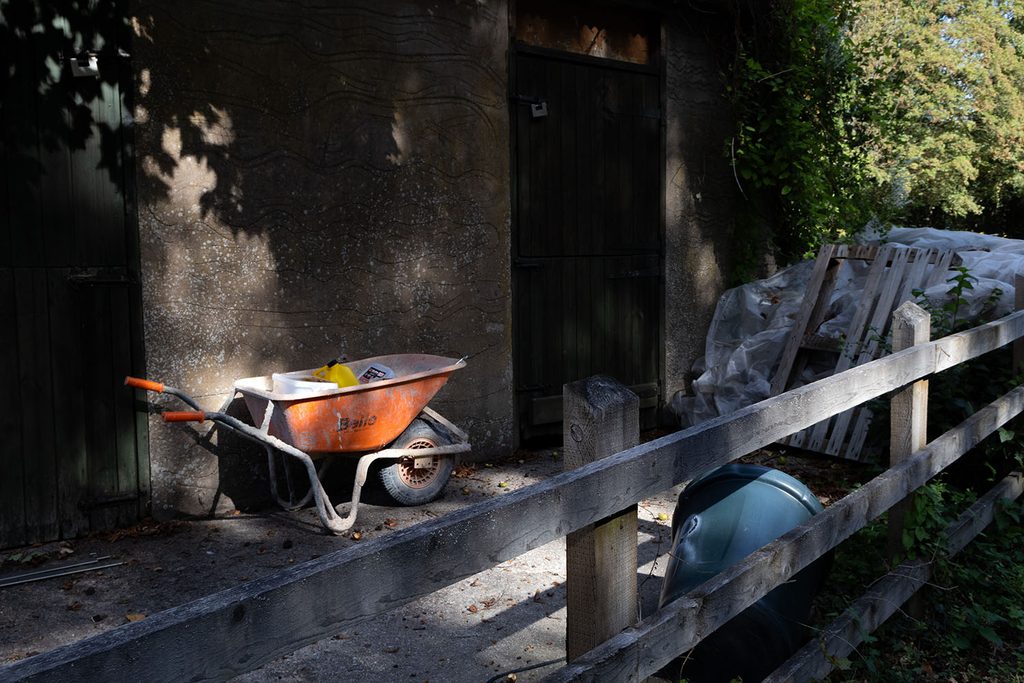 Wheelbarrow placed between two doors into a building
